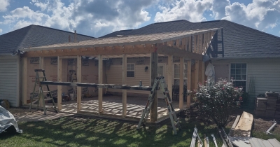 Framing out windows of a sunroom installation.